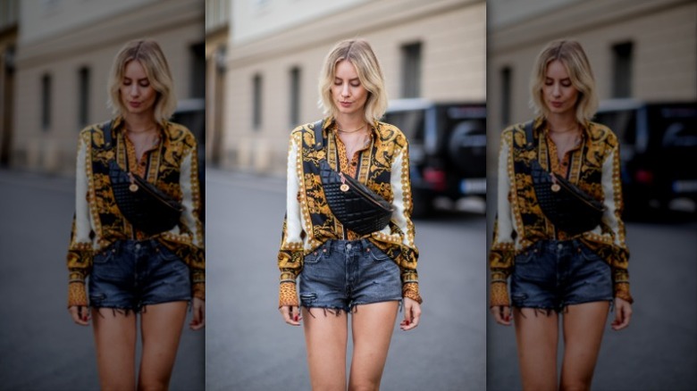 woman wearing Versace print blouse