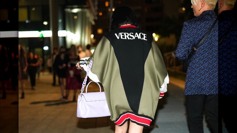 guest wearing oversized Versace jacket