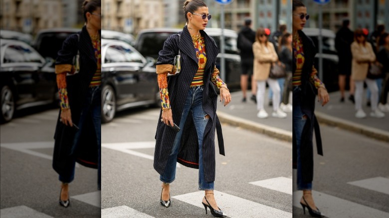 Woman wearing pinstriped coat, jeans