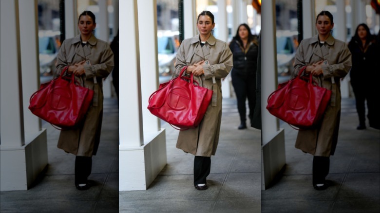 woman holding a red large leather tote