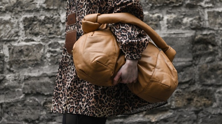 woman holding a large puffy brown bag