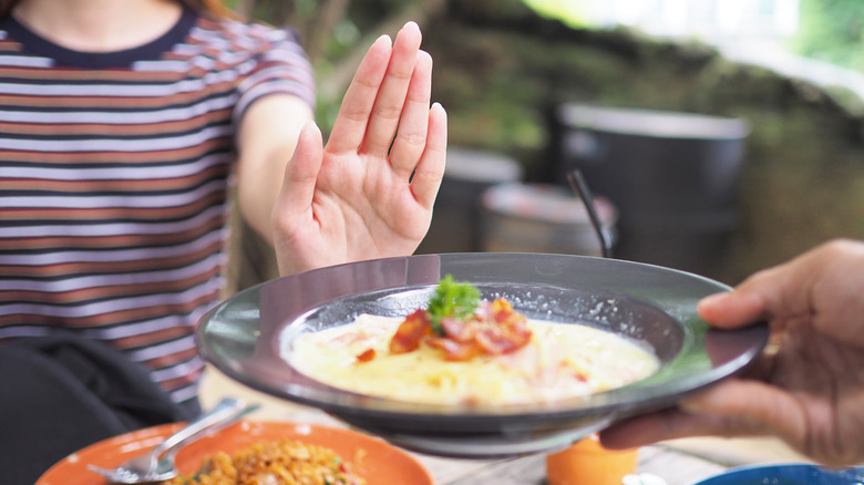 woman declining meal at restaurant