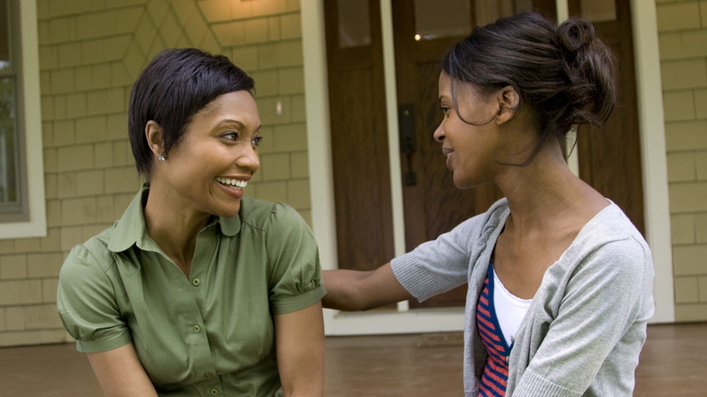 two women smiling and talking