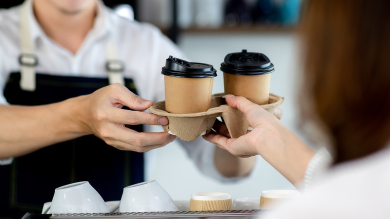 woman buying coffee at cafe