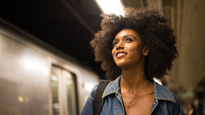 Smiling Black woman in subway station