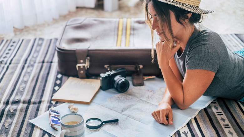 Woman studying travel map