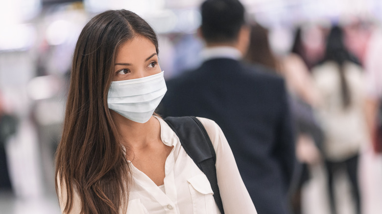 Asian woman wearing mask in public place