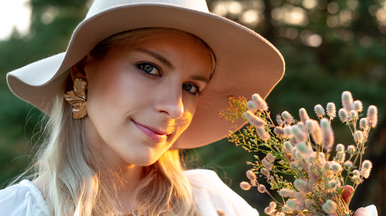 Floppy hat and floral earrings