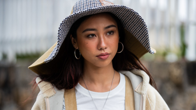 Woman wearing floppy houndstooth hat