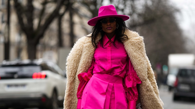 Woman wearing hot pink outfit with hat