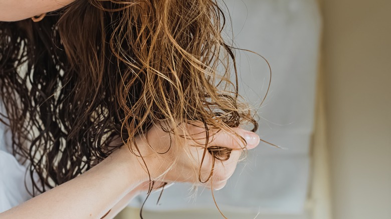 Scrunching mousse in wavy hair