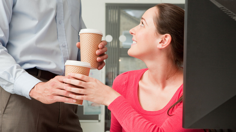 man bringing woman coffee