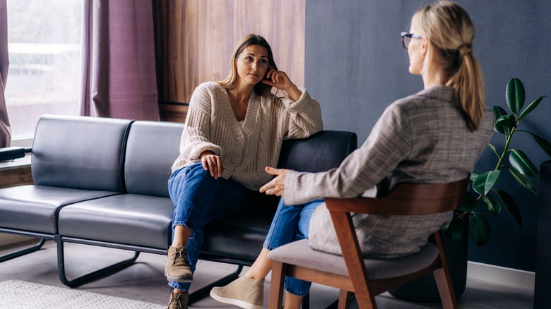 Woman listens as friend speaks 