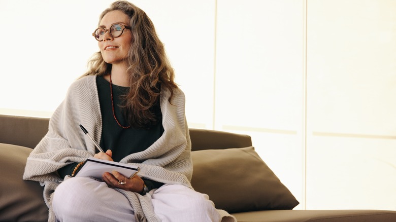 Woman writes goals in journal