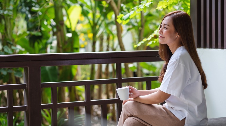 woman drinking coffee outside