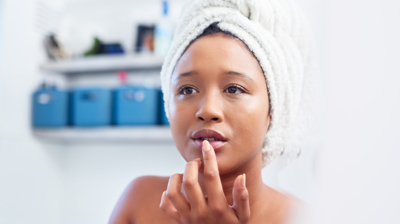 woman applying lip balm