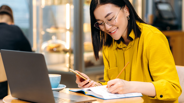 woman doing work at coffee shop