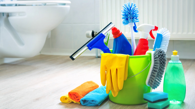 Clean old dirty bathroom floors and walls, bathroom cleaning tools to try  and remove dirt, mold and corrosion from white bathroom tiles. Stock Photo