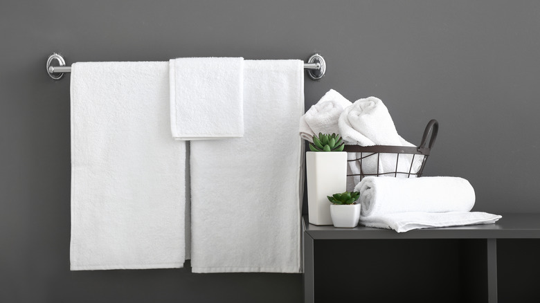 bath towels hang on a bar, gray wall background