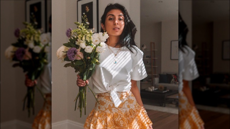 Woman holding flowers wearing t-shirt