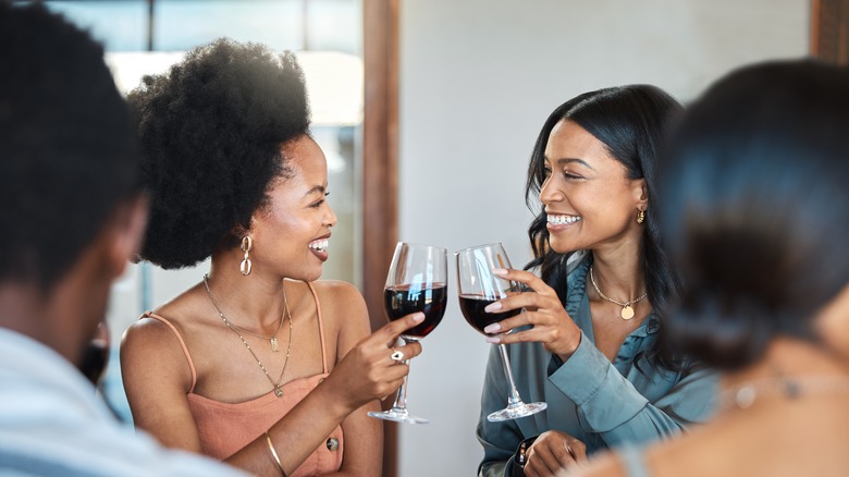 Women clinking wine glasses