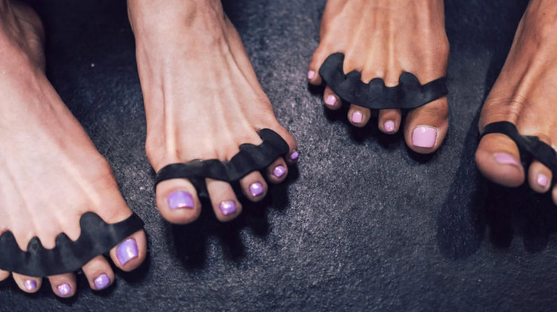 black toe-spreaders on feet