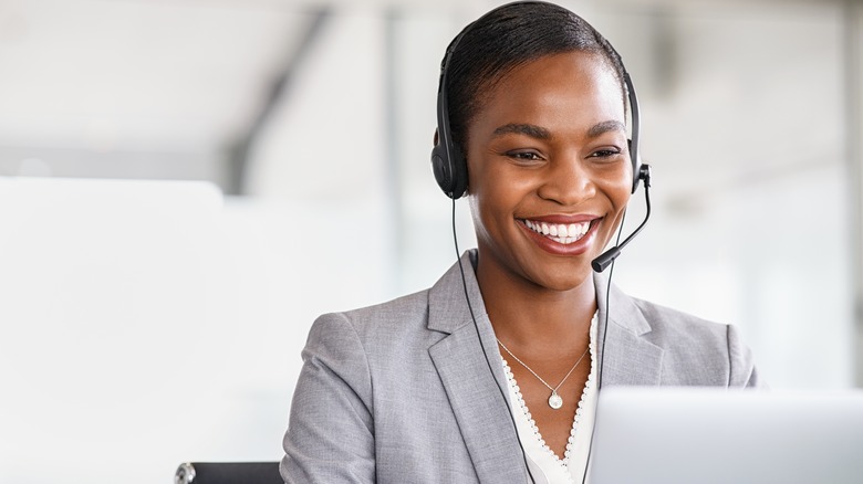 Businesswoman smiling with headset and laptop