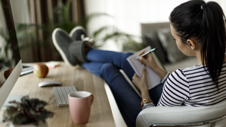 Woman writing in notebook