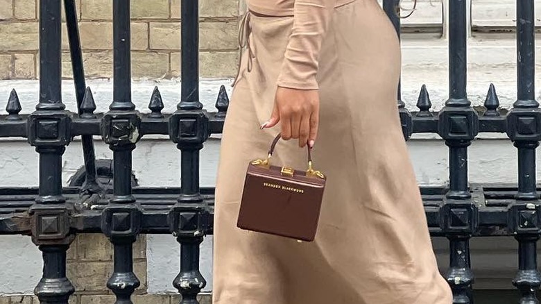 Girl carrying a box bag