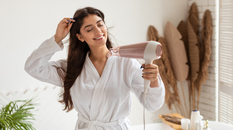 smiling woman drying hair