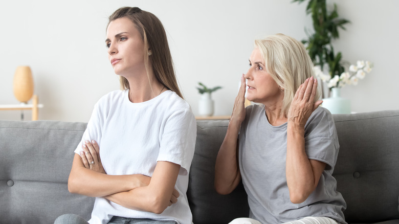 Older woman scolding young woman