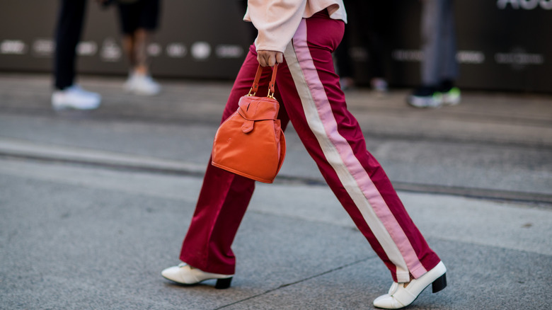 https://www.glam.com/img/gallery/track-pants-are-a-legitimate-fashion-choice-and-we-can-prove-it/intro-1688909009.jpg