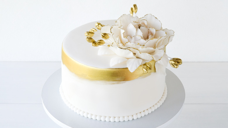 Top tier of white and gold wedding cake