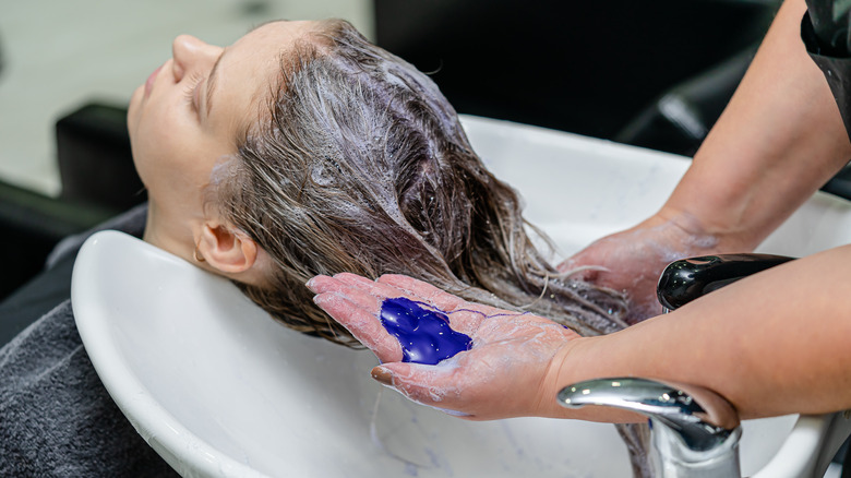 hairstylist using purple shampoo