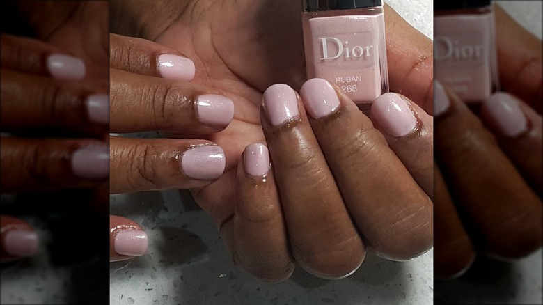 Hand holding Dior Ruban nail polish