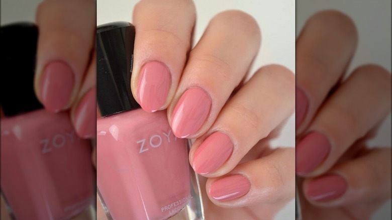 Hand holding Zoya nail polish