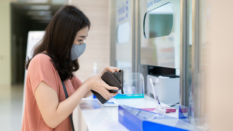 person paying at doctor's office