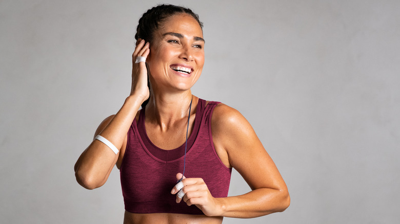 A woman smiling with headphones