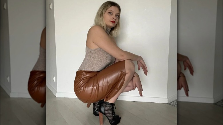 Woman poses in leather skirt 