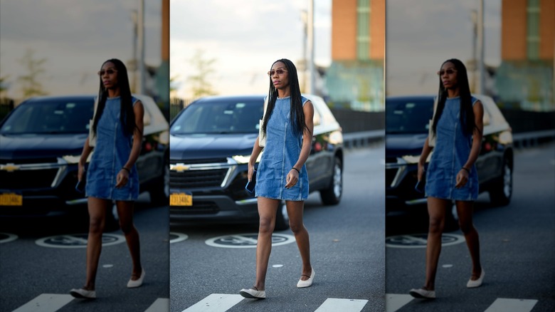 Woman crossing street in denim mini dress