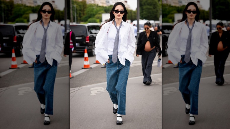 Woman crossing street wearing open-shirt and tie