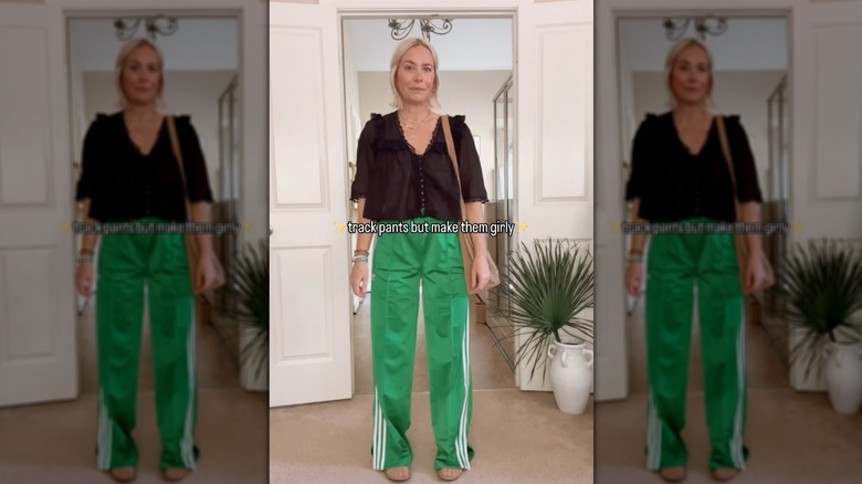 Woman posing in green tracksuit bottoms