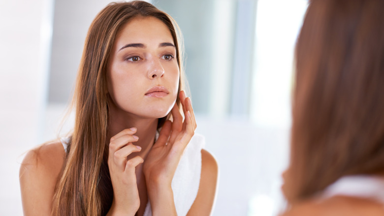 A woman touching her face