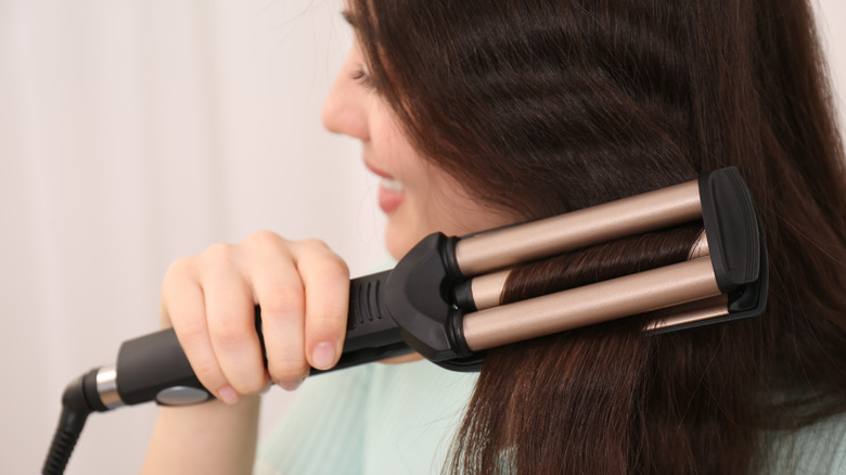 woman using waving iron