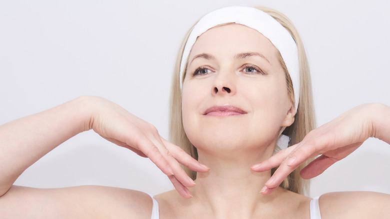 woman running hands under chin