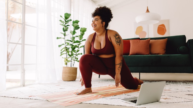 Plus-sized woman exercising at home