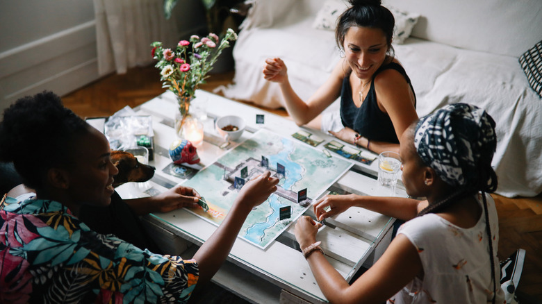 Friends play a boardgame 