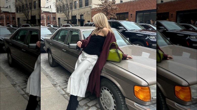 Woman wearing a corset over her slip dress.