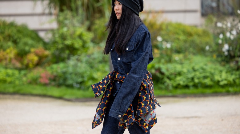 woman wearing denim and tied sweater