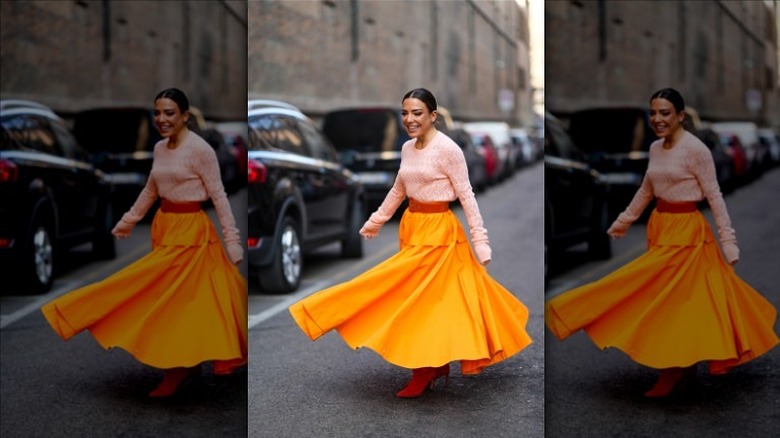 woman wearing orange maxi skirt
